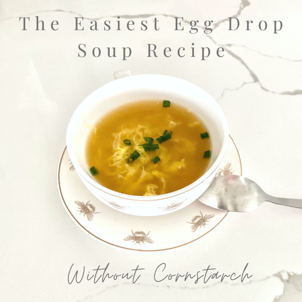 egg drop soup in a white bowl on a white counter top